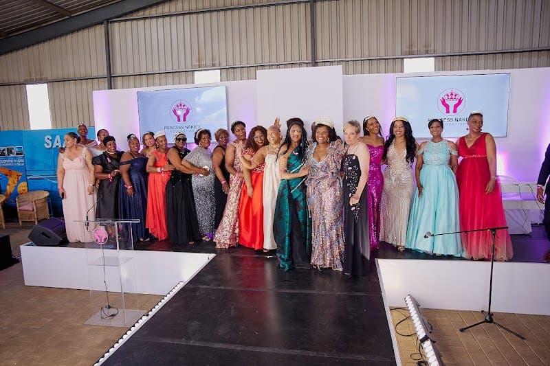 Community members stand together on a runway at a foundation event.