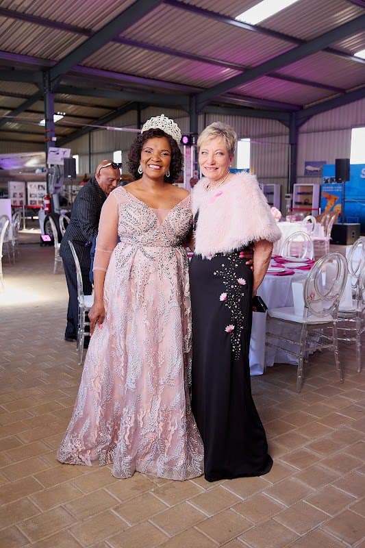 Two guests walk together at a foundation celebration.