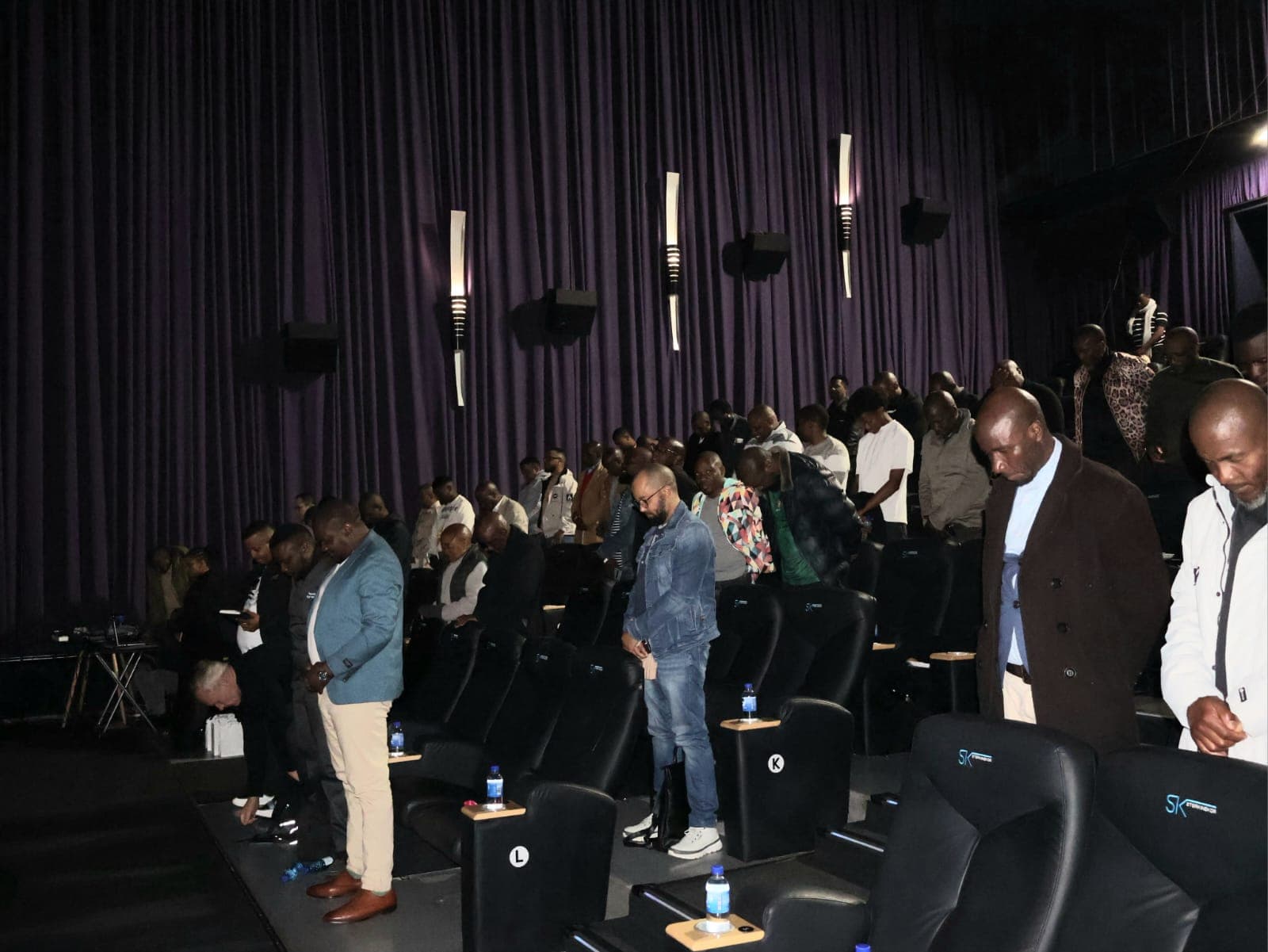 Guests stand among the cinema seats during Men’s Chests United.